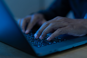 hands typing on laptop